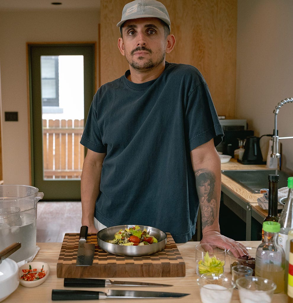 Chef Vince Morelli stands in his kitchen, presenting his squid salad. Click to read his interview.