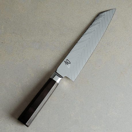 Dual Core Kiritsuke knife on a light stone surface.