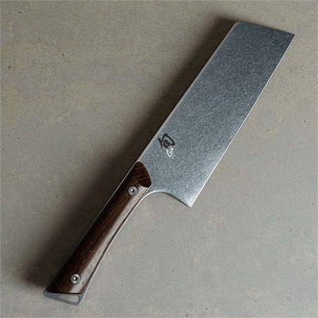 Kanso Asian Utility Knife on a light stone surface.