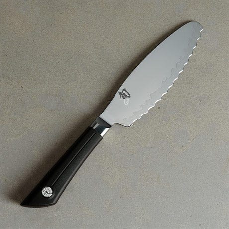 Sora Ultimate Utility Knife on a light stone surface.