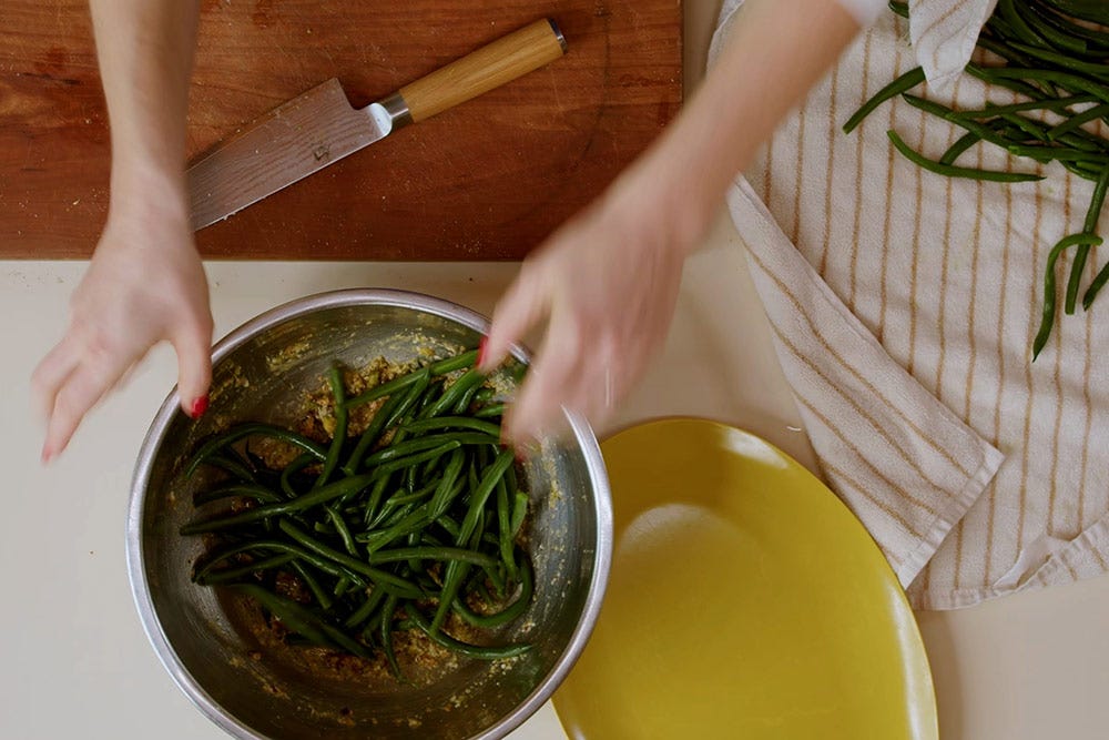 Close up Molly Baz preparing her green beans - click for the recipe page.