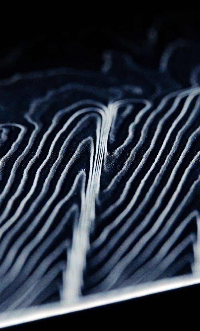 Close-up of layered Damascus steel pattern on a Shun Shiranami knife blade