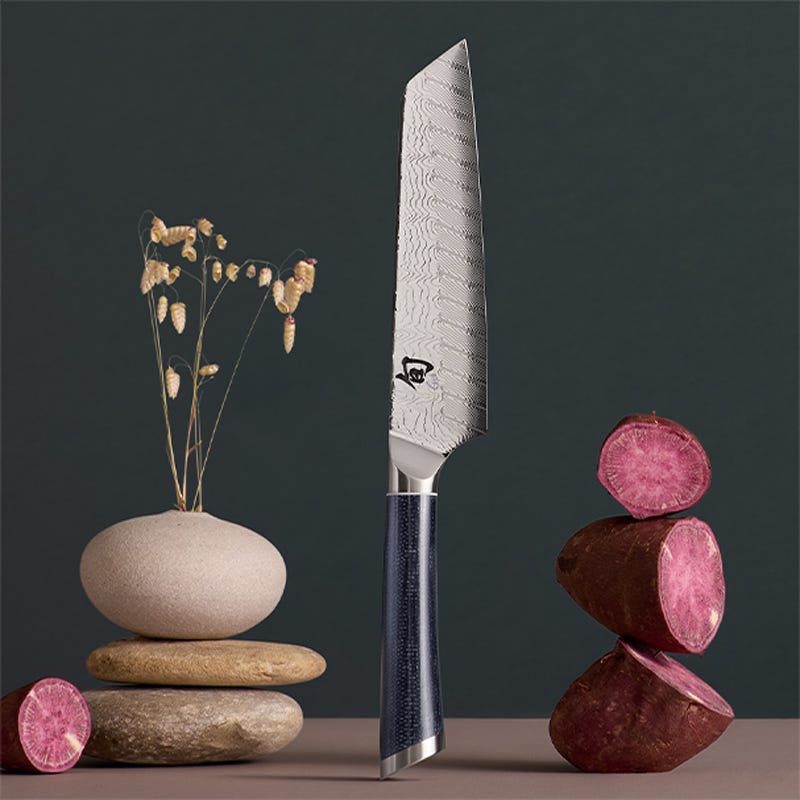 Shun Shiranami 6.5-inch master utility knife styled with stacked stones and sliced root vegetables