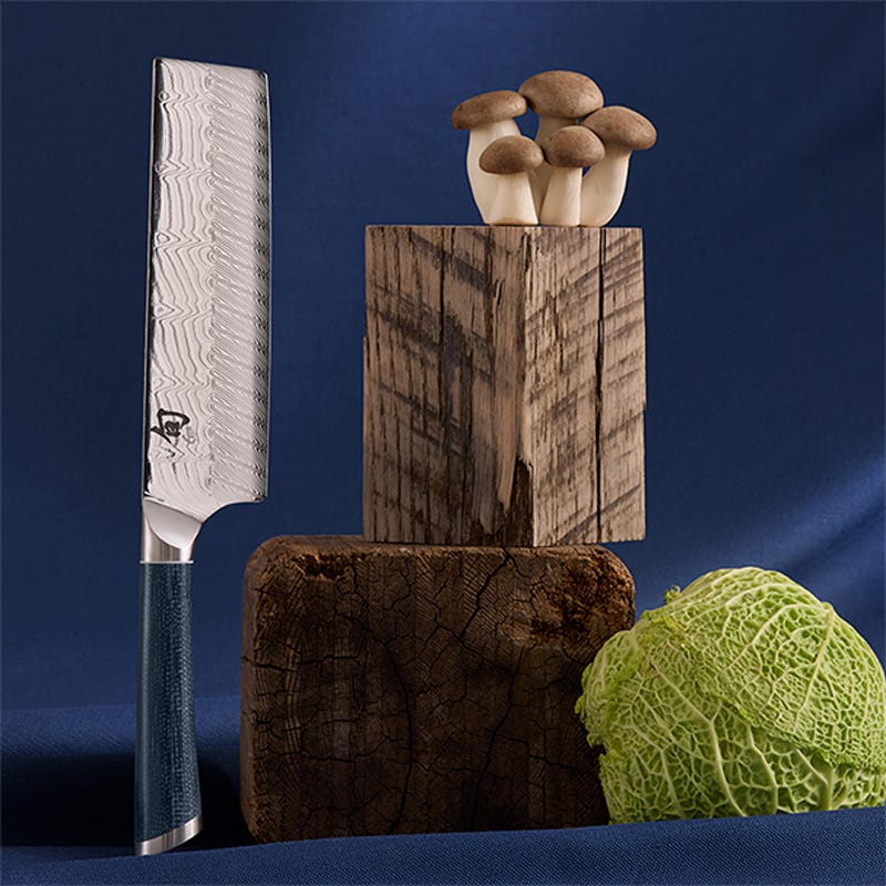 Shun Shiranami 6.5-inch nakiri vegetable knife with Damascus blade beside cabbage and mushrooms