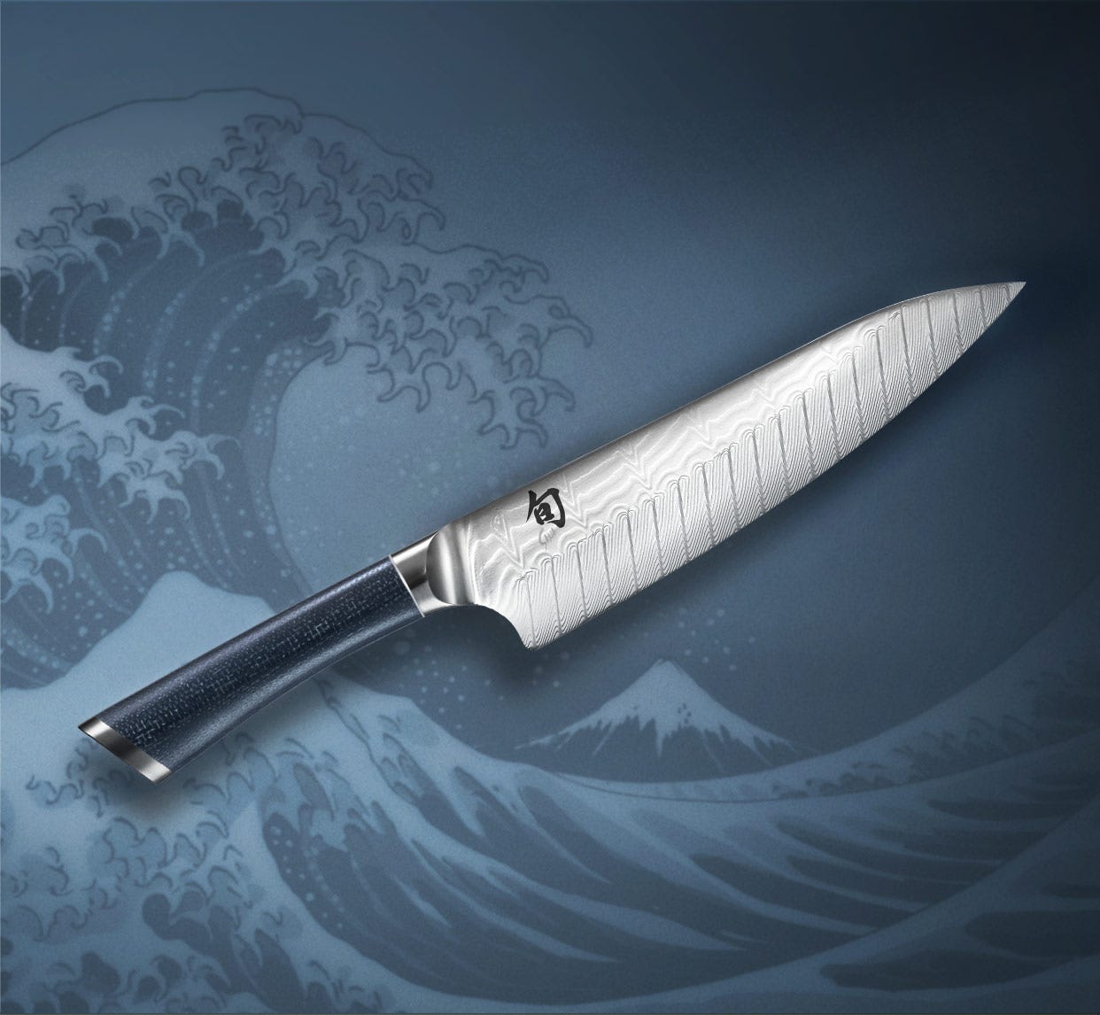 Shun Shiranami knife over stylized Japanese wave artwork.