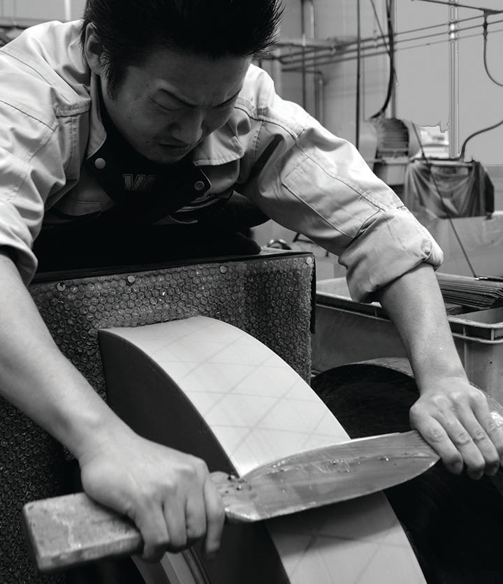 Man grinding knife