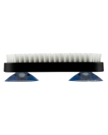 Side view of the Shun Burr Brush showing firm white bristles, a black rectangular body, and two blue suction cups for secure countertop placement.