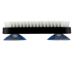 Side view of the Shun Burr Brush showing firm white bristles, a black rectangular body, and two blue suction cups for secure countertop placement.